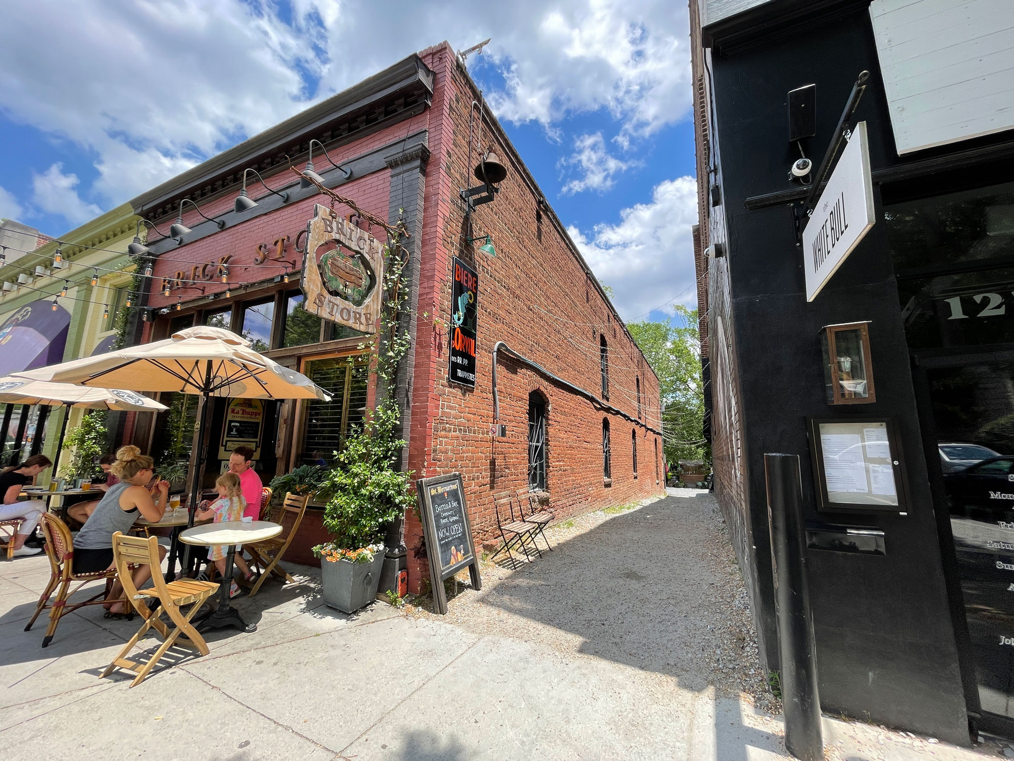 Brick Store Pub exterior facade with people sitting in front at tables