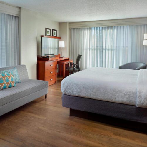 Hotel Room With Bed And Couch At Courtyard By Marriott