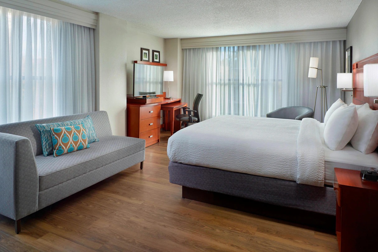 hotel room with bed and couch at Courtyard by Marriott