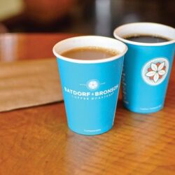 Two Bright Blue Cups Filled With Coffee At Dancing Goats