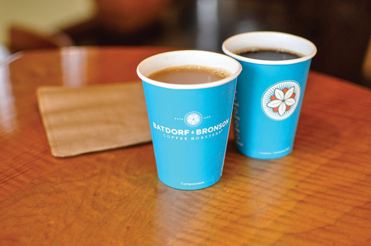 two bright blue cups filled with coffee at Dancing Goats