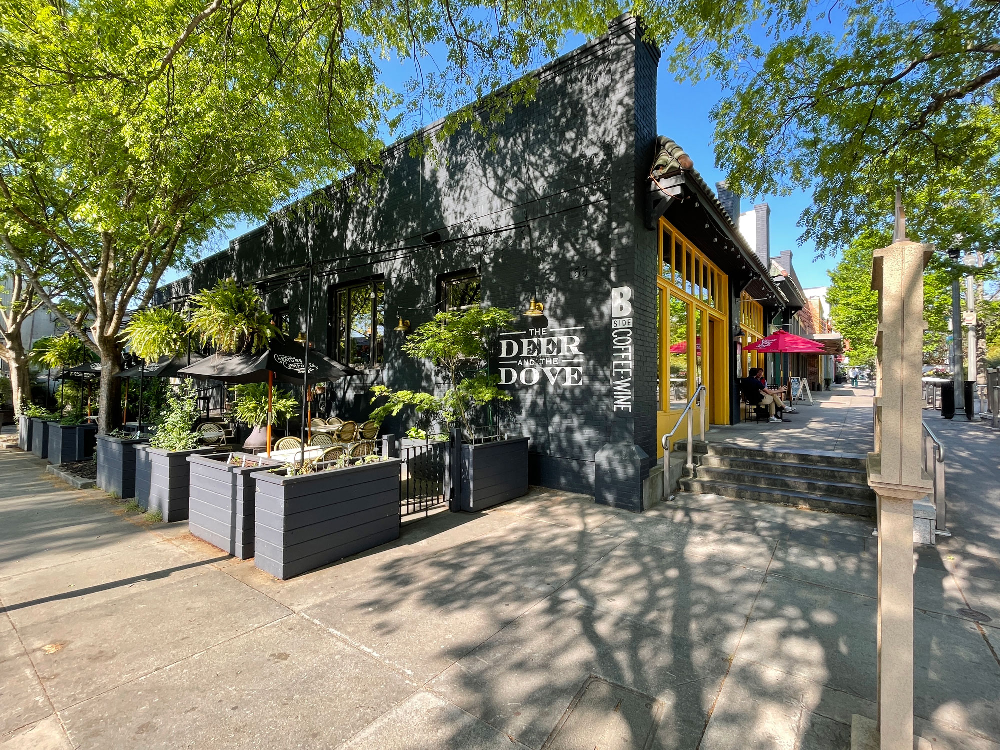 Deer and the Dove restaurant exterior with shady sidewalk patio