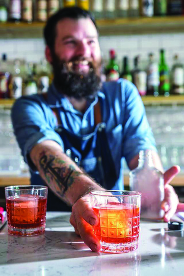 Bartender serves drink at White Bull