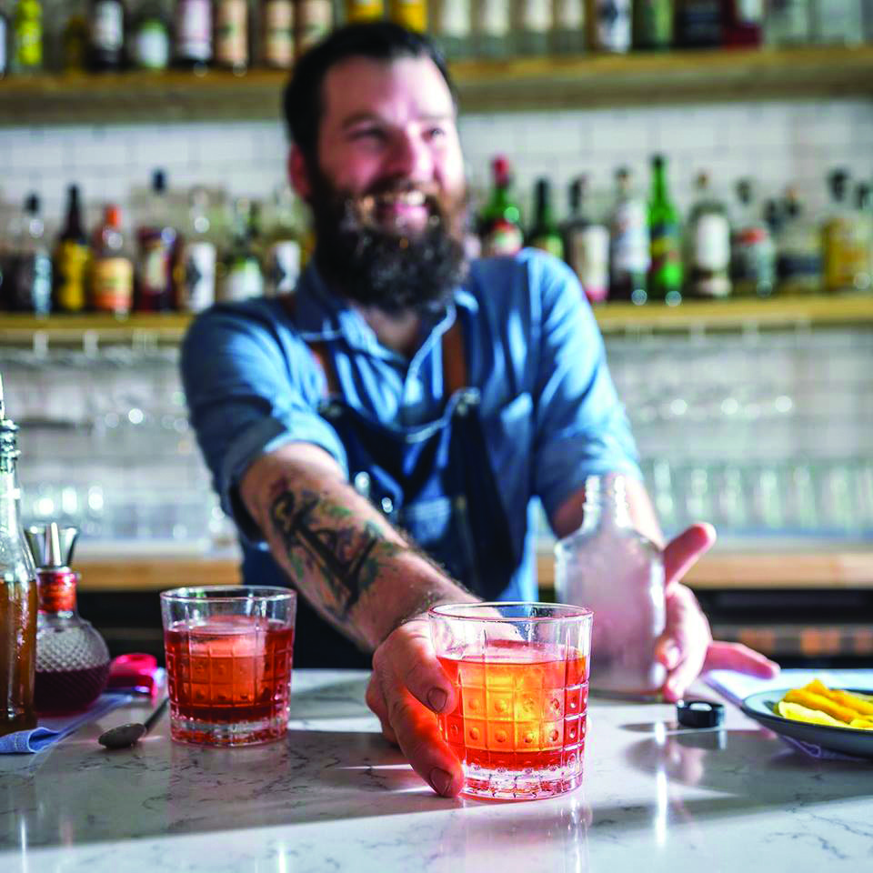 Bartender serves drink at White Bull