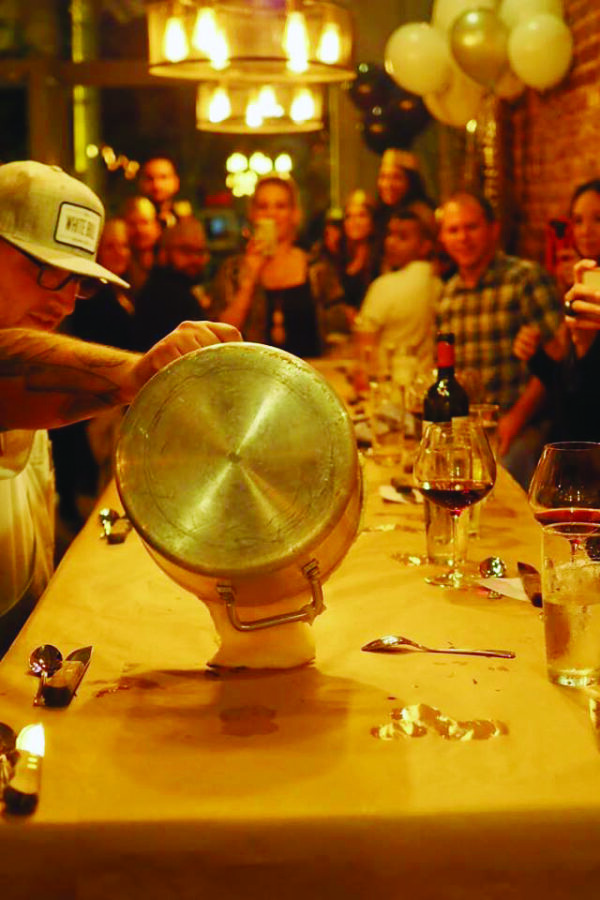 Chef pours polenta down table at White Bull