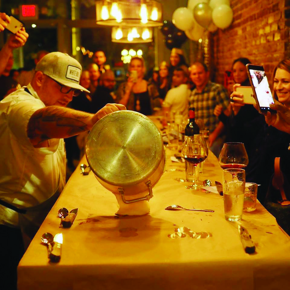 Chef pours polenta down table at White Bull