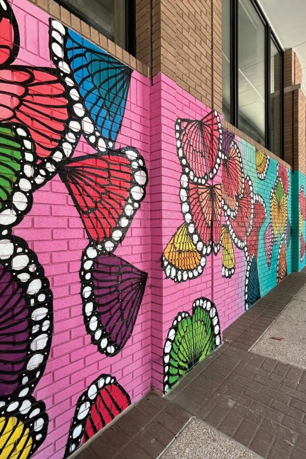 Bright butterfly mural spanning outdoor corridor