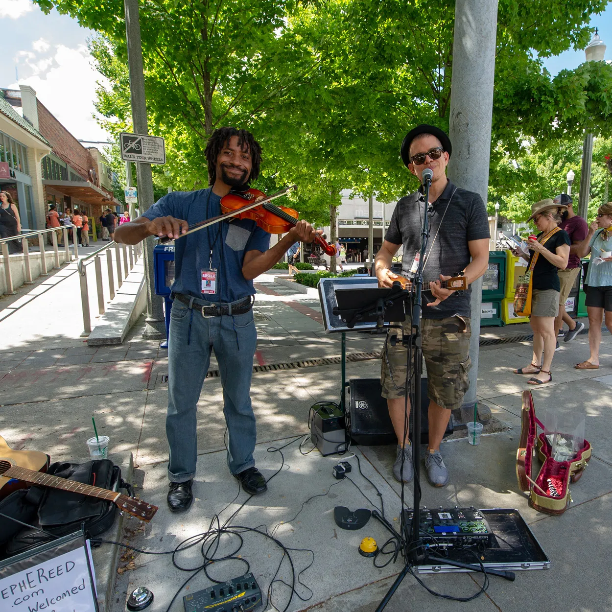 black violinist and white guitarist busking in downtown Decatur