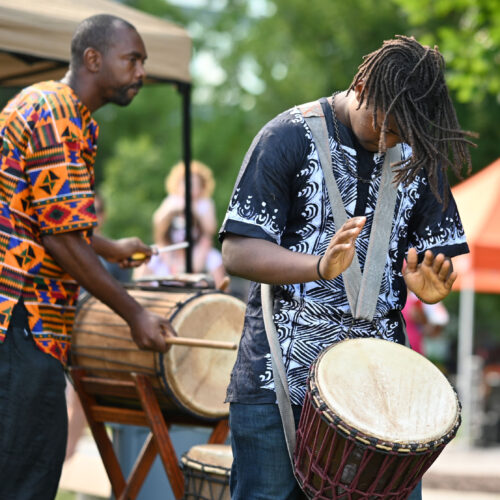 Two Black men playing drums