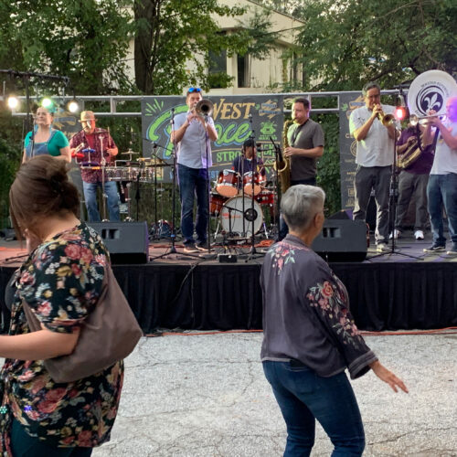 band playing on stage in parking lot at West Ponce Music Stroll