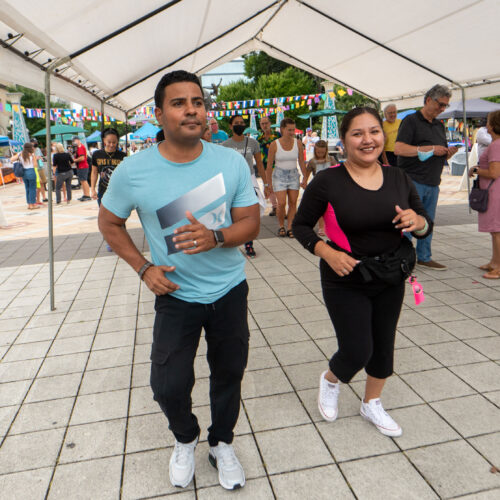 mand and woman salsa dancing on the downtown square