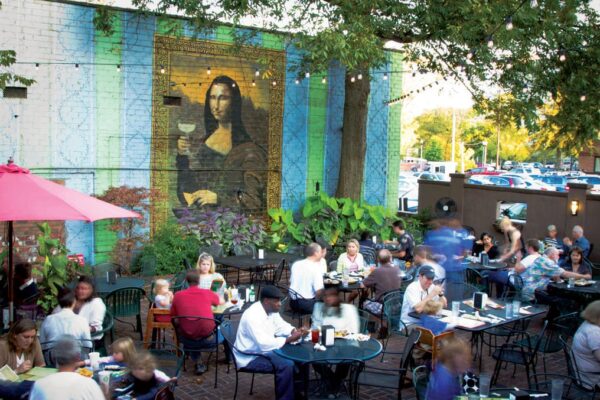 Raging Burrito back patio with mural of Mona Lisa holding margarita