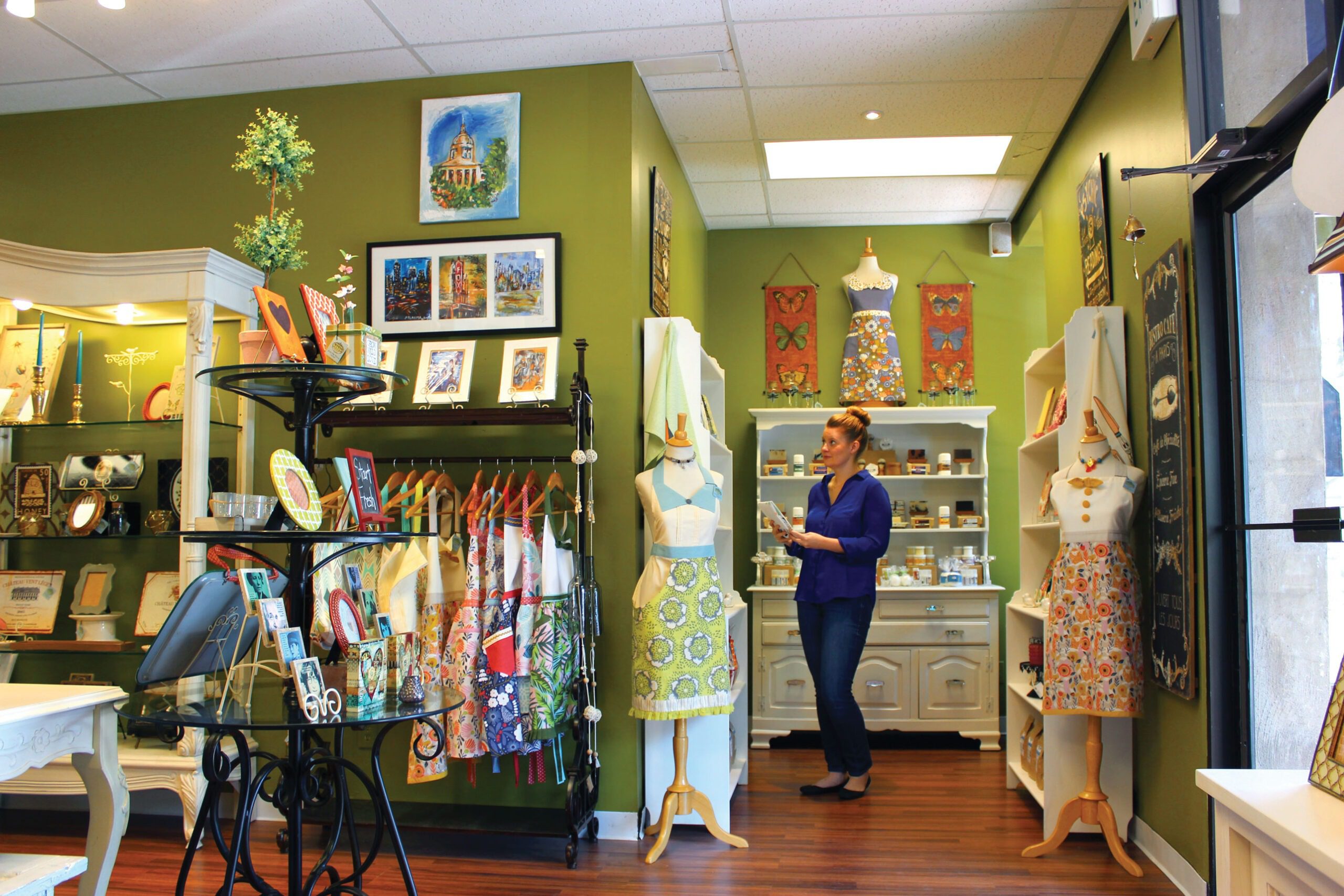 Vivid Boutique shop interior with aprons, frames, prints, and bath goods