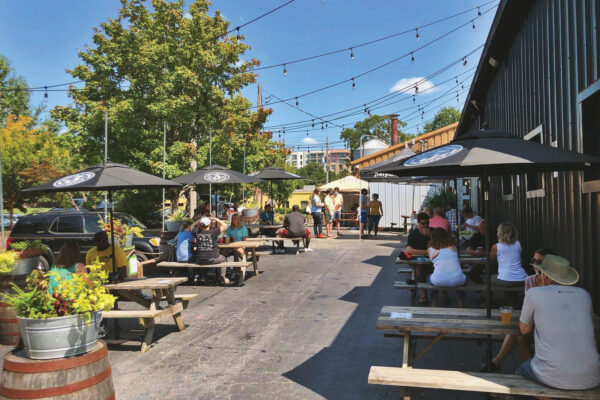 outdoor picnic table seating at Three Taverns Brewery